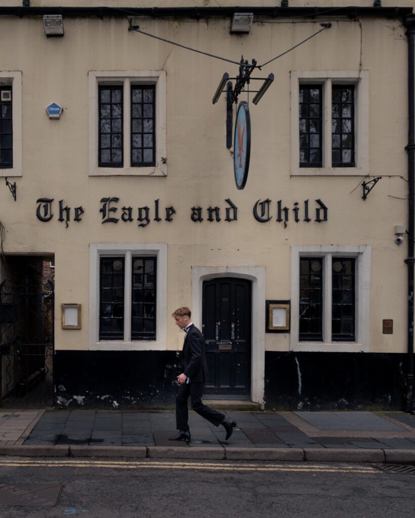 a boy in front of an english pub
