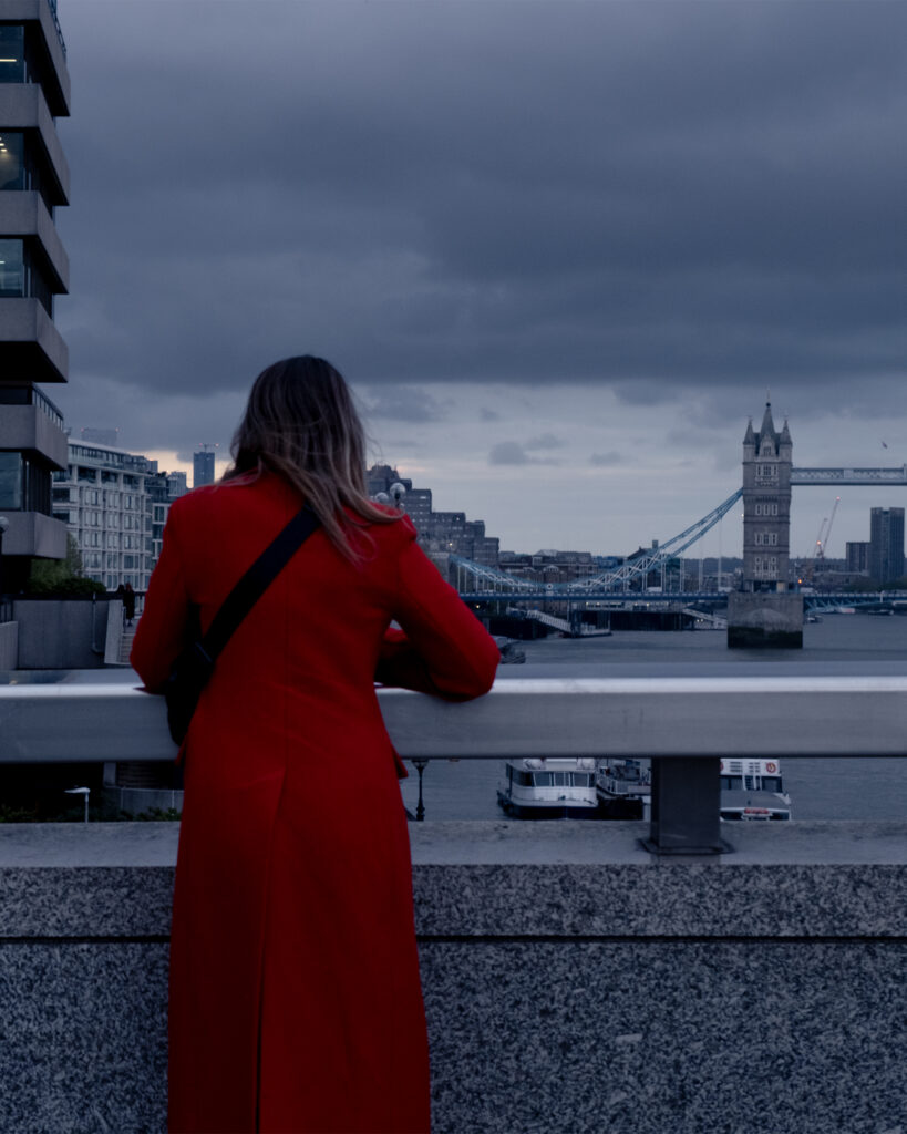 a woman on a red dress in the London Bridge
